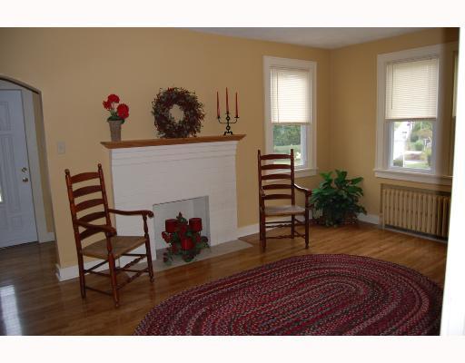 14 Braddock Rd Avenue Mount Pleasant, PA 15666 - Photo 3 of 10 Living Room. Cozy living room with gorgeous new hardwood floors, stamped concrete fireplace hearth & oak mantel, and recessed lights. New windows throughout