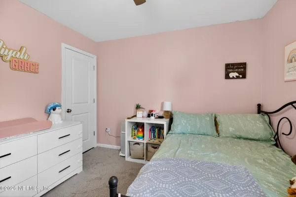 a bedroom with a bed and a couch