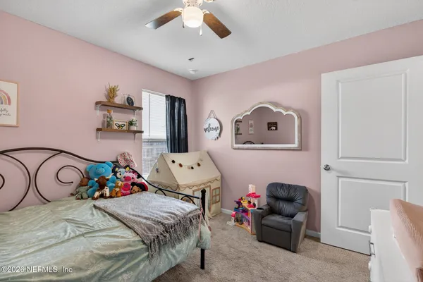 a bedroom with furniture and a chandelier