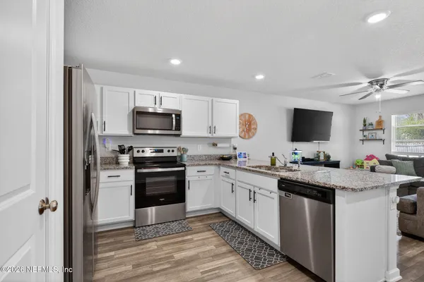 a kitchen with a sink stove and microwave