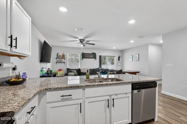 a kitchen with a sink stove and cabinets