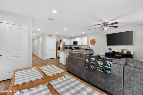 a living room with furniture and a flat screen tv