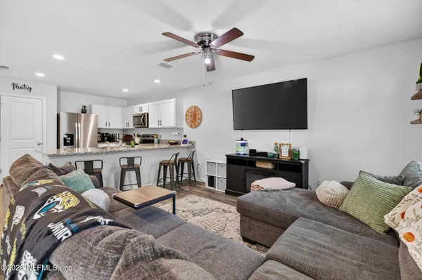 a living room with furniture and a flat screen tv
