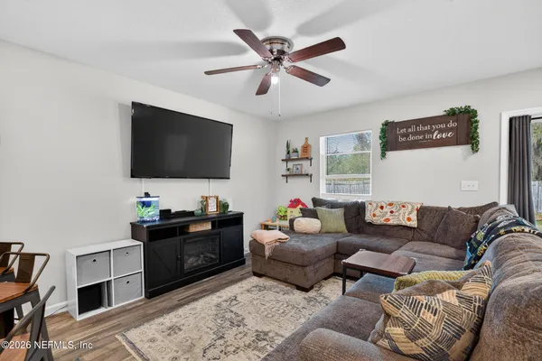 a living room with furniture and a flat screen tv