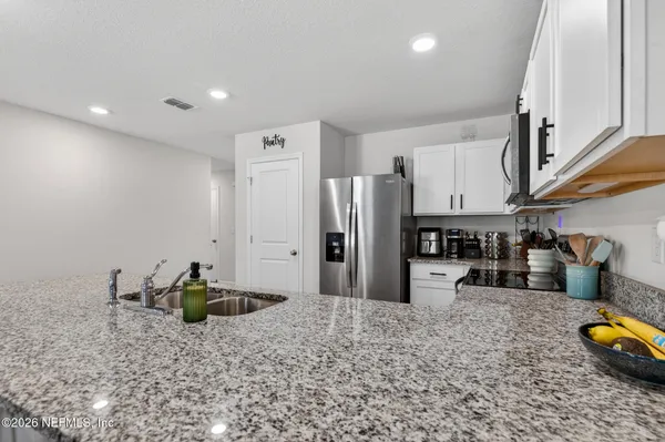 a kitchen with refrigerator and cabinets