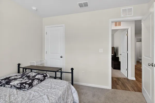 a bedroom with a bed and a table in it