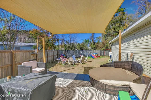 a view of a chairs and table in backyard