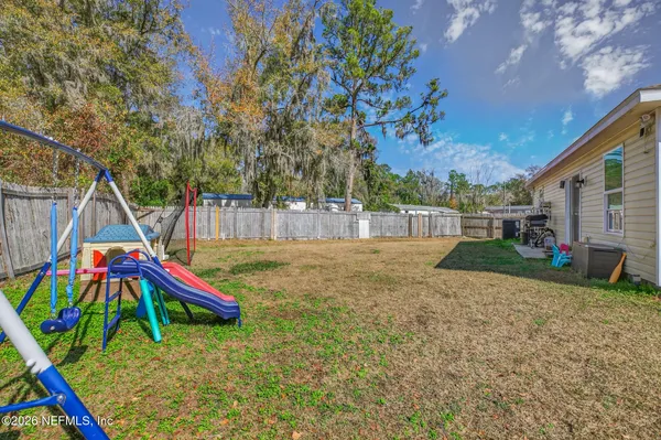 a view of backyard with deck and entertaining space