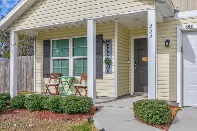 a front view of a house with outdoor seating and plants