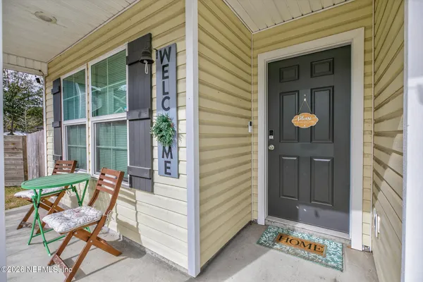 a view of an entryway with a table and chairs