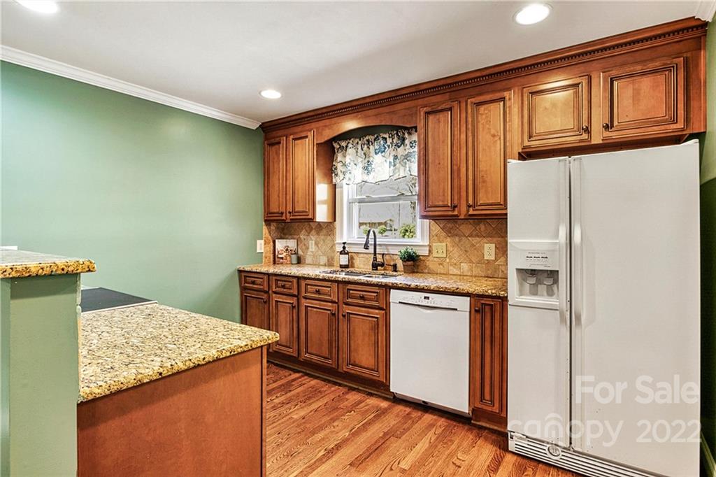 422 Fieldstone Road Mooresville, NC 28115 - Photo 12 of 36 a kitchen with stainless steel appliances granite countertop a refrigerator a sink dishwasher a stove with wooden cabinets and floor