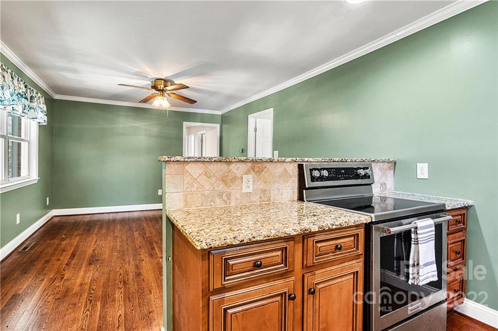 422 Fieldstone Road Mooresville, NC 28115 - Photo 13 of 36 a kitchen with kitchen island a stove and a sink