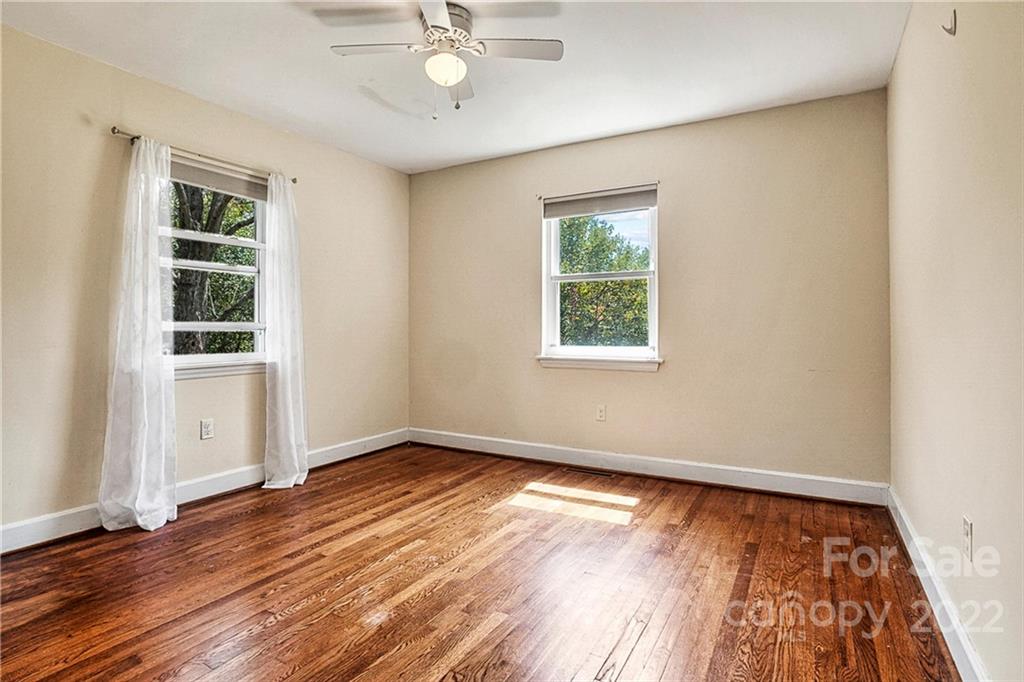 422 Fieldstone Road Mooresville, NC 28115 - Photo 20 of 36 an empty room with wooden floor cabinet and windows