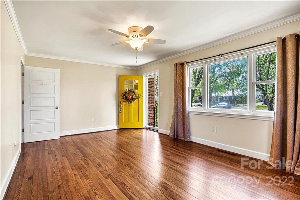 422 Fieldstone Road Mooresville, NC 28115 - Photo 7 of 36 a view of an empty room with a window and wooden floor