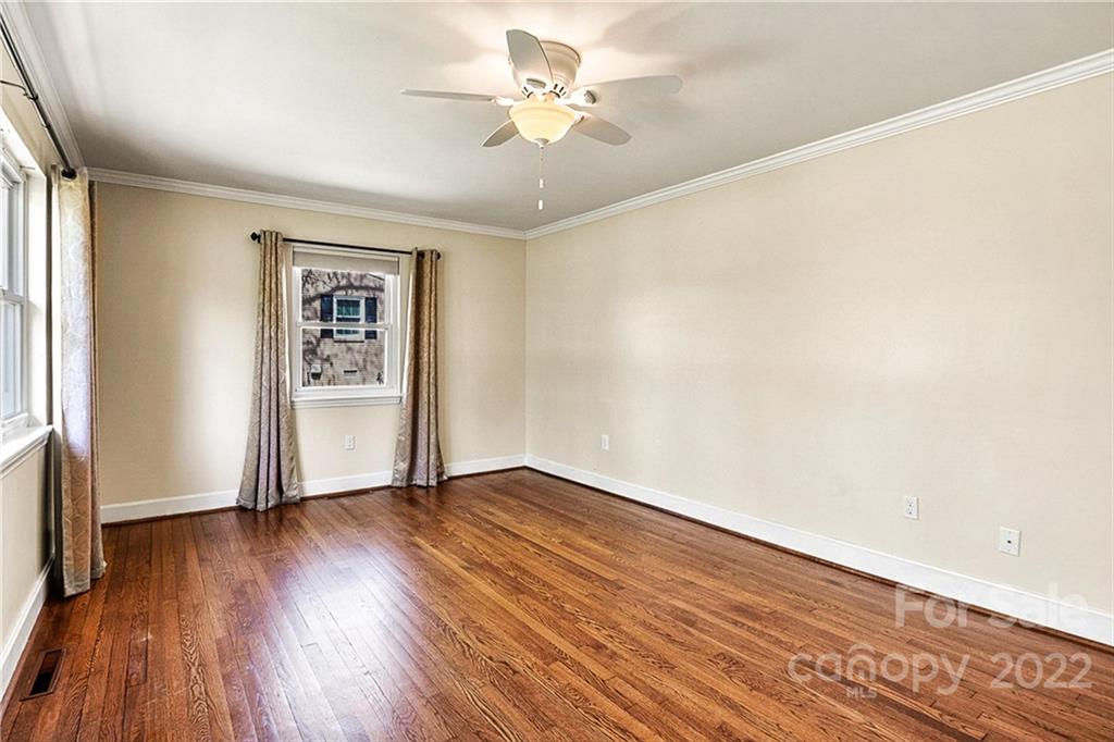 422 Fieldstone Road Mooresville, NC 28115 - Photo 8 of 36 an empty room with wooden floor chandelier fan and windows
