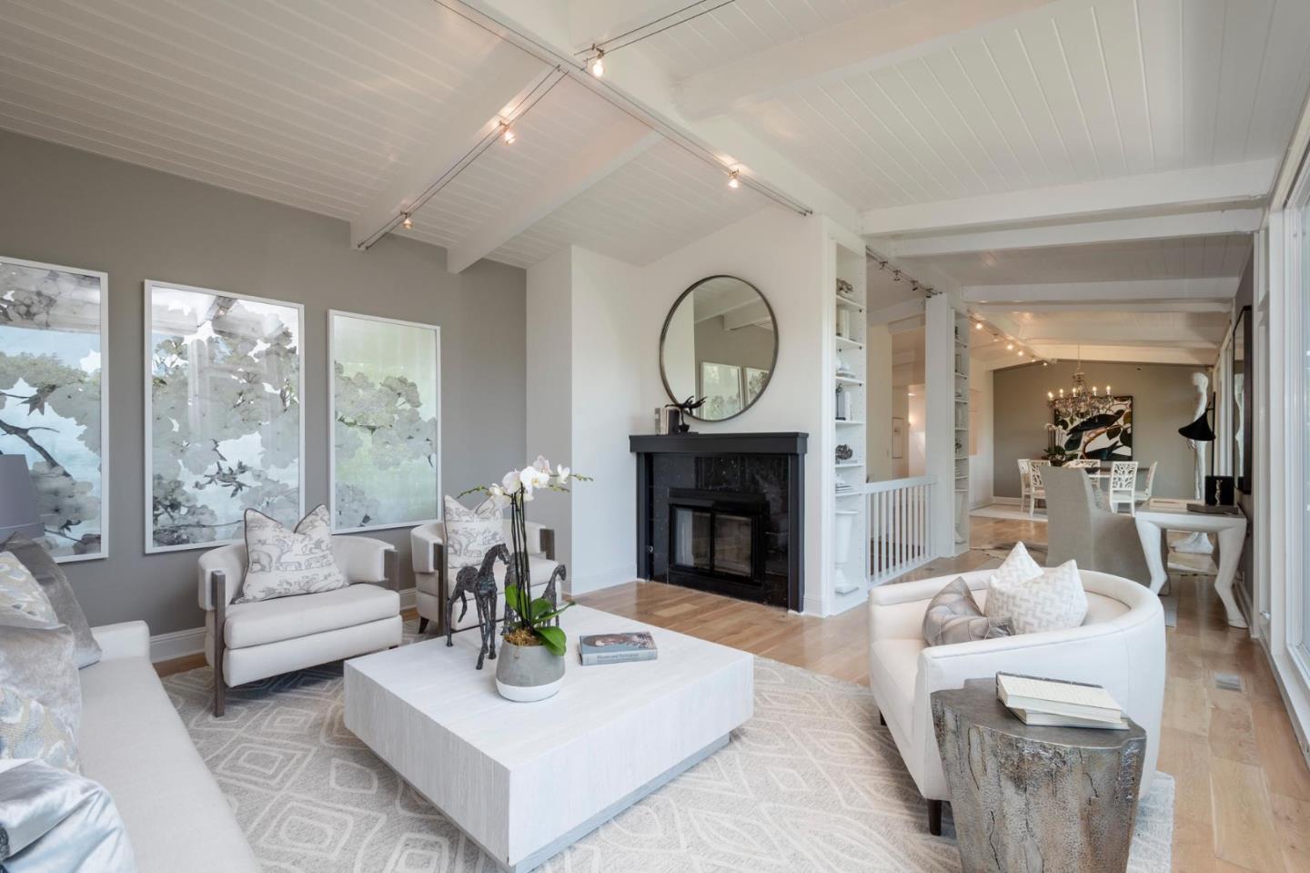 775 Bowhill Road Hillsborough, CA 94010 - Photo 11 of 28 a living room with furniture a fireplace and a large window