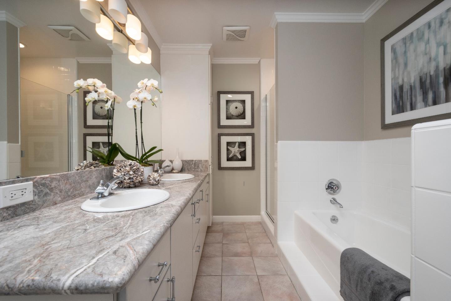 775 Bowhill Road Hillsborough, CA 94010 - Photo 16 of 28 a bathroom with a tub a sink and a mirror
