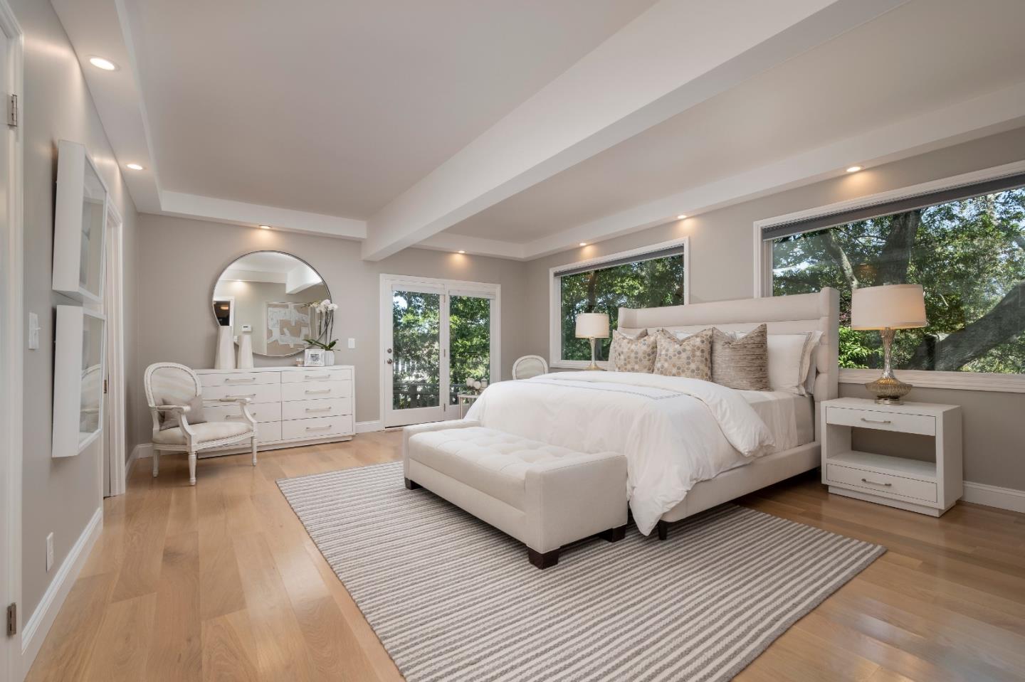 775 Bowhill Road Hillsborough, CA 94010 - Photo 20 of 28 a bedroom with a large bed mirror and windows