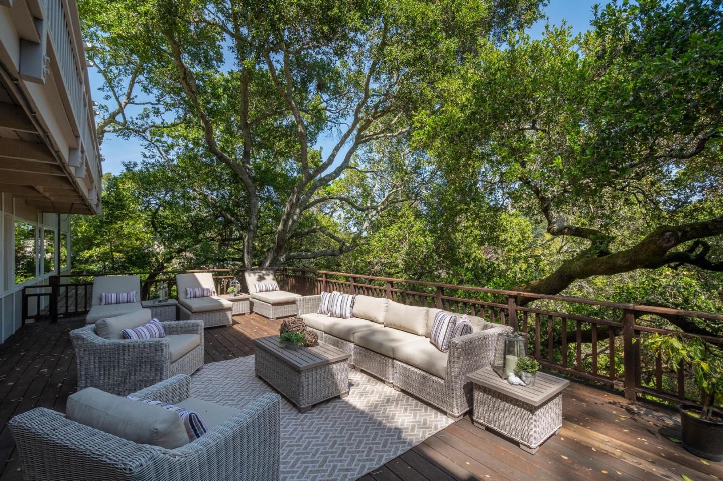 775 Bowhill Road Hillsborough, CA 94010 - Photo 27 of 28 a view of a patio with couches and a table and chairs with floor to ceiling window and tree