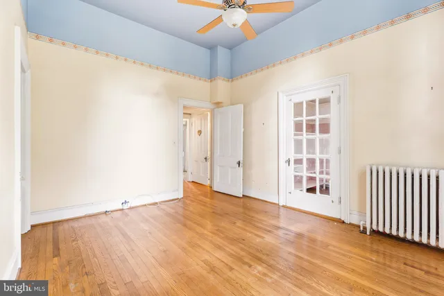 a view of staircase with lots of frames and white walls