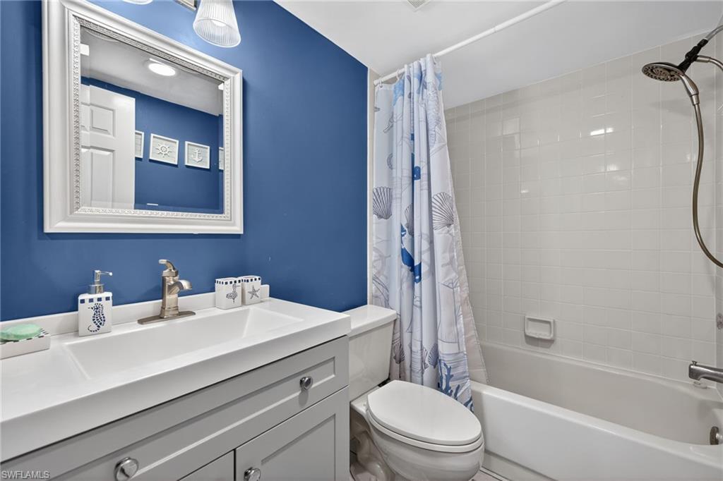 4973 Pepper Circle, Unit F105 Naples, FL 34113 - Photo 14 of 21 a bathroom with a sink a toilet and shower