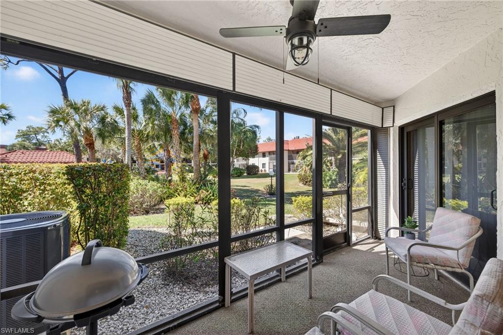 4973 Pepper Circle, Unit F105 Naples, FL 34113 - Photo 15 of 21 a living room with large windows