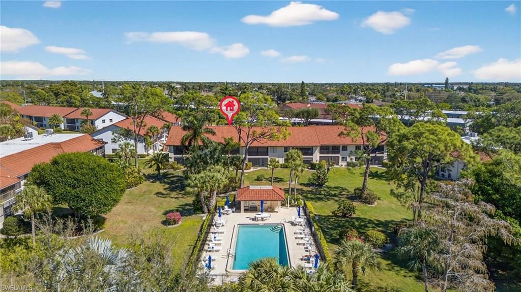 4973 Pepper Circle, Unit F105 Naples, FL 34113 - Photo 18 of 21 an aerial view of residential houses with outdoor space and street view