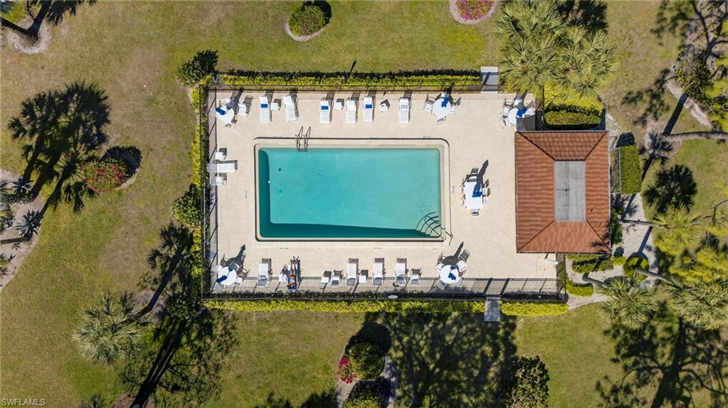 4973 Pepper Circle, Unit F105 Naples, FL 34113 - Photo 19 of 21 a front view of a house with a garden