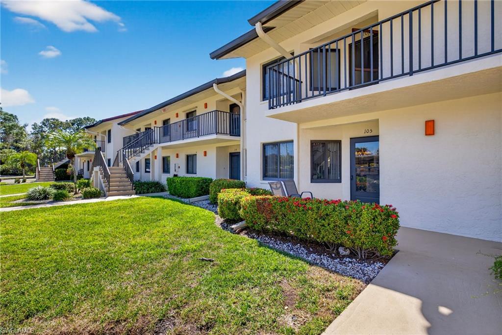 4973 Pepper Circle, Unit F105 Naples, FL 34113 - Photo 20 of 21 a front view of a house with garden