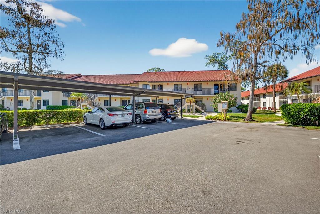 4973 Pepper Circle, Unit F105 Naples, FL 34113 - Photo 21 of 21 a car parked in front of a building