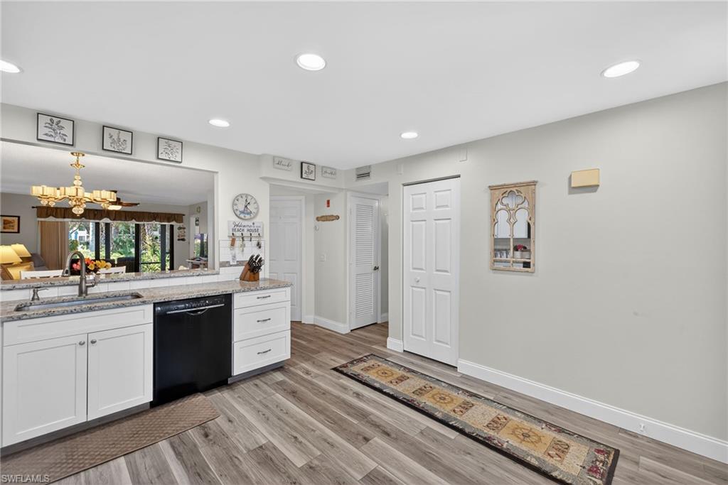 4973 Pepper Circle, Unit F105 Naples, FL 34113 - Photo 3 of 21 a large white kitchen with a sink and dishwasher stove top oven