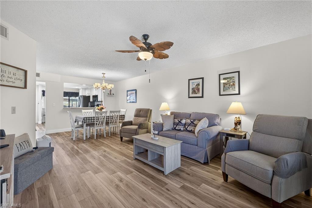 4973 Pepper Circle, Unit F105 Naples, FL 34113 - Photo 8 of 21 a living room with furniture a view of bedroom and a couch