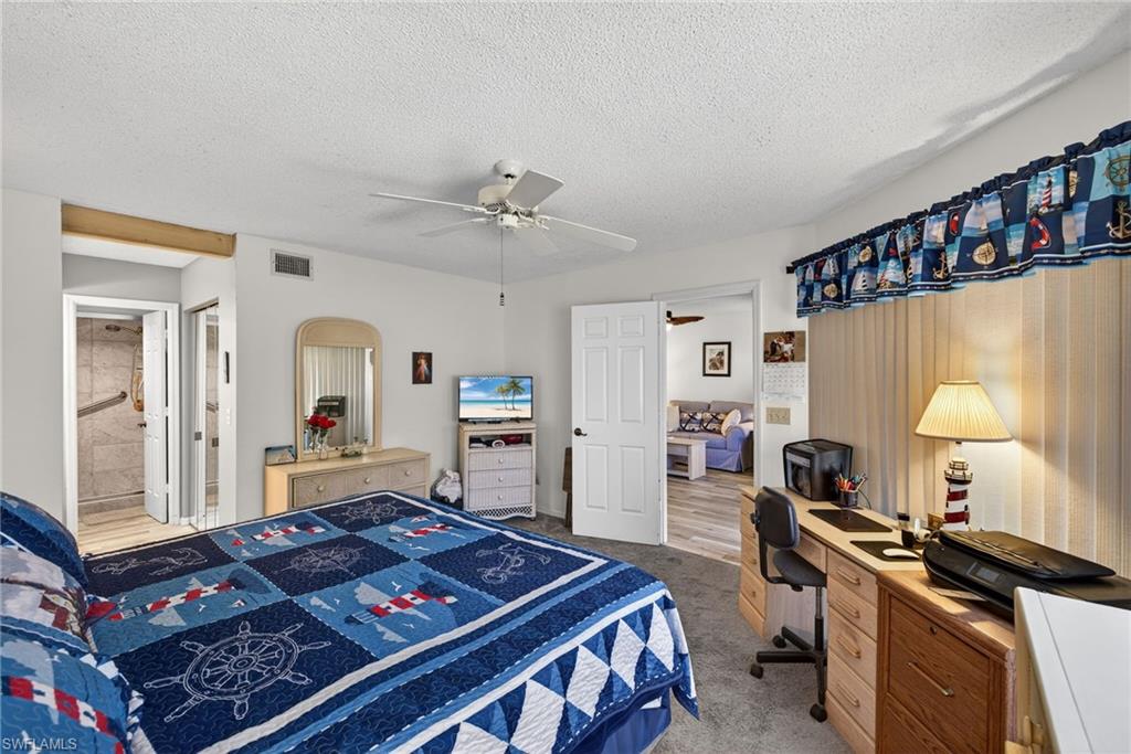 4973 Pepper Circle, Unit F105 Naples, FL 34113 - Photo 10 of 21 a living room with furniture and a window