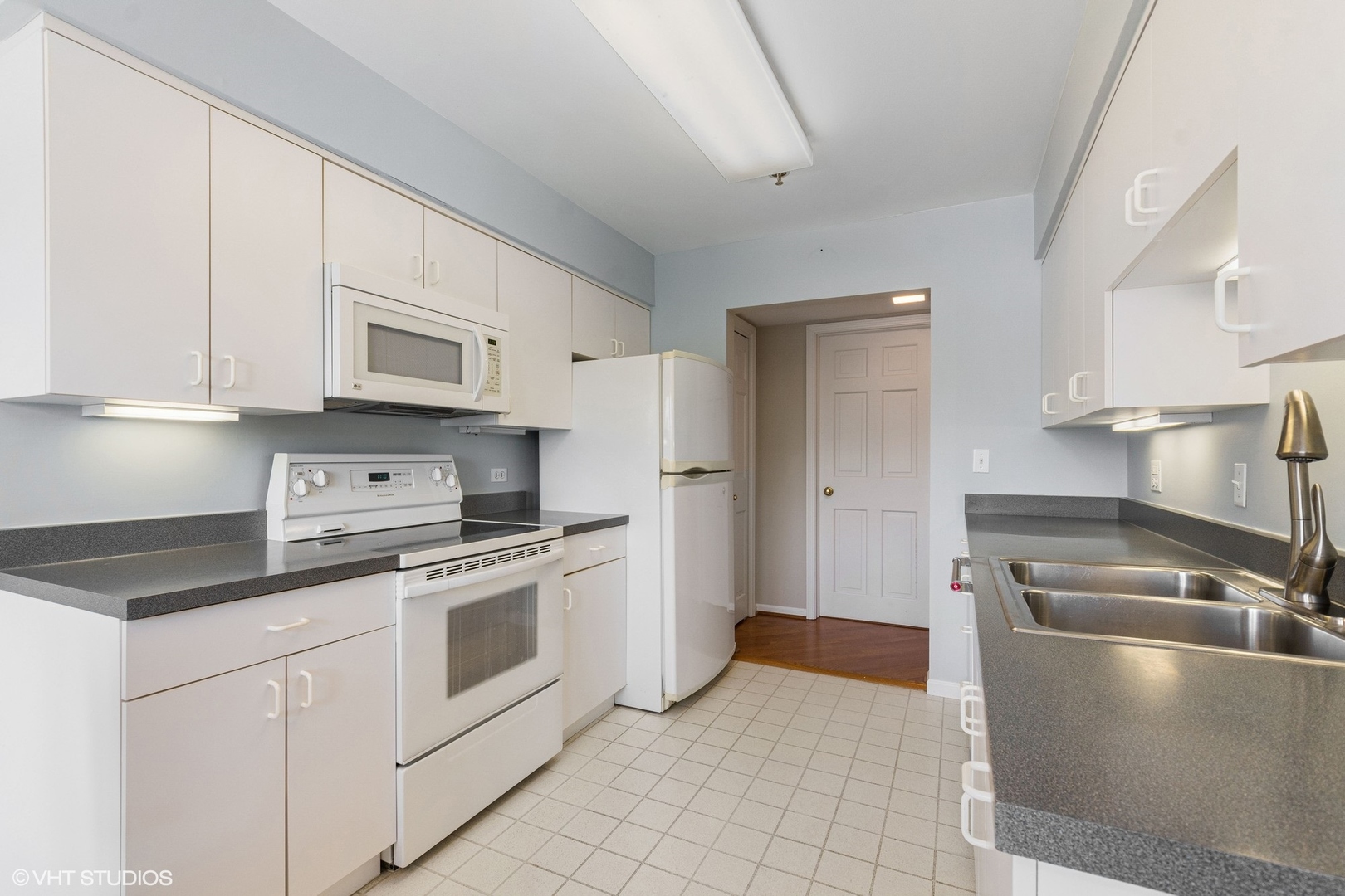308 North Happ Road, Unit 310 Northfield, IL 60093 - Photo 6 of 17 a kitchen with stainless steel appliances granite countertop a sink and a stove