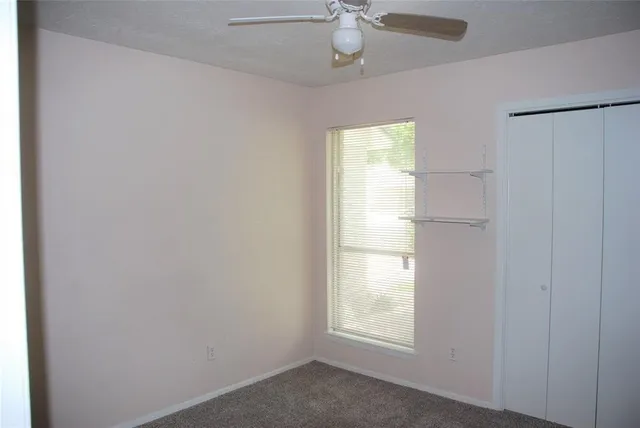 a view of a kitchen area with white cabinets