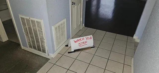 a view of an empty room with a rug