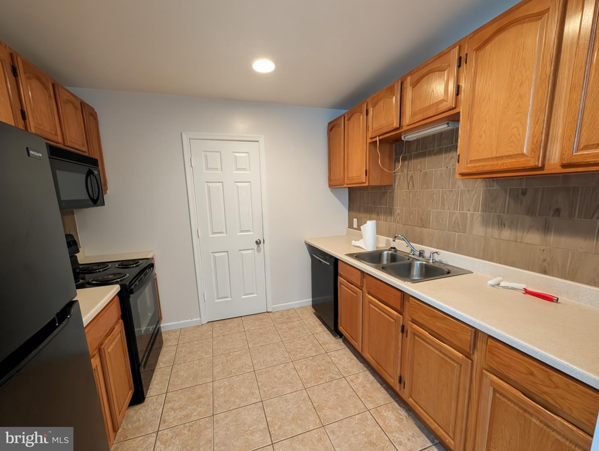 383 Nottingham Road Quarryville, PA 17566 - Photo 5 of 10 a kitchen with a sink a stove and refrigerator