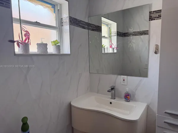 a bathroom with a sink and mirror