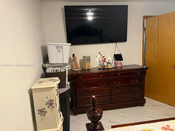 a living room with a furniture and a flat screen tv
