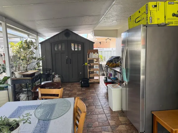 a kitchen with stainless steel appliances granite countertop a refrigerator and a fireplace