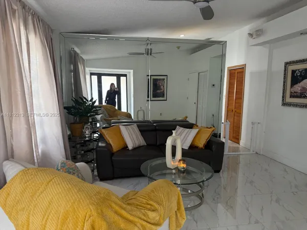 a living room with furniture window and a wooden floor