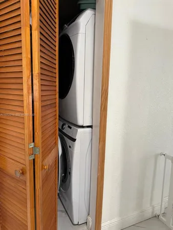a close view of a utility room with dryer and washer