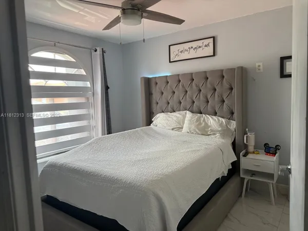 a bedroom with a bed and a window