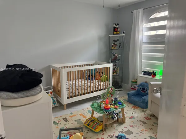 a bedroom with furniture a rug and a window