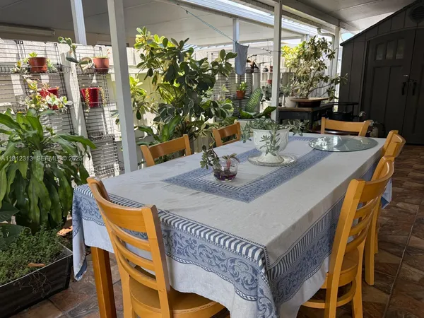 a view of an outdoor dining space with a table and chairs