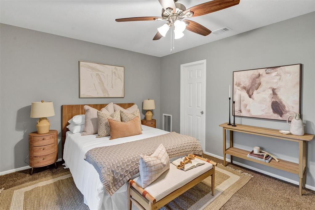 1009 Russell Road Everman, TX 76140 - Photo 11 of 20 a bedroom with bed and a painting on the wall