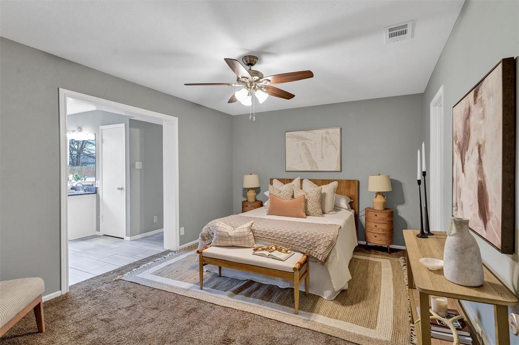 1009 Russell Road Everman, TX 76140 - Photo 12 of 20 a bedroom with a bed and a chandelier