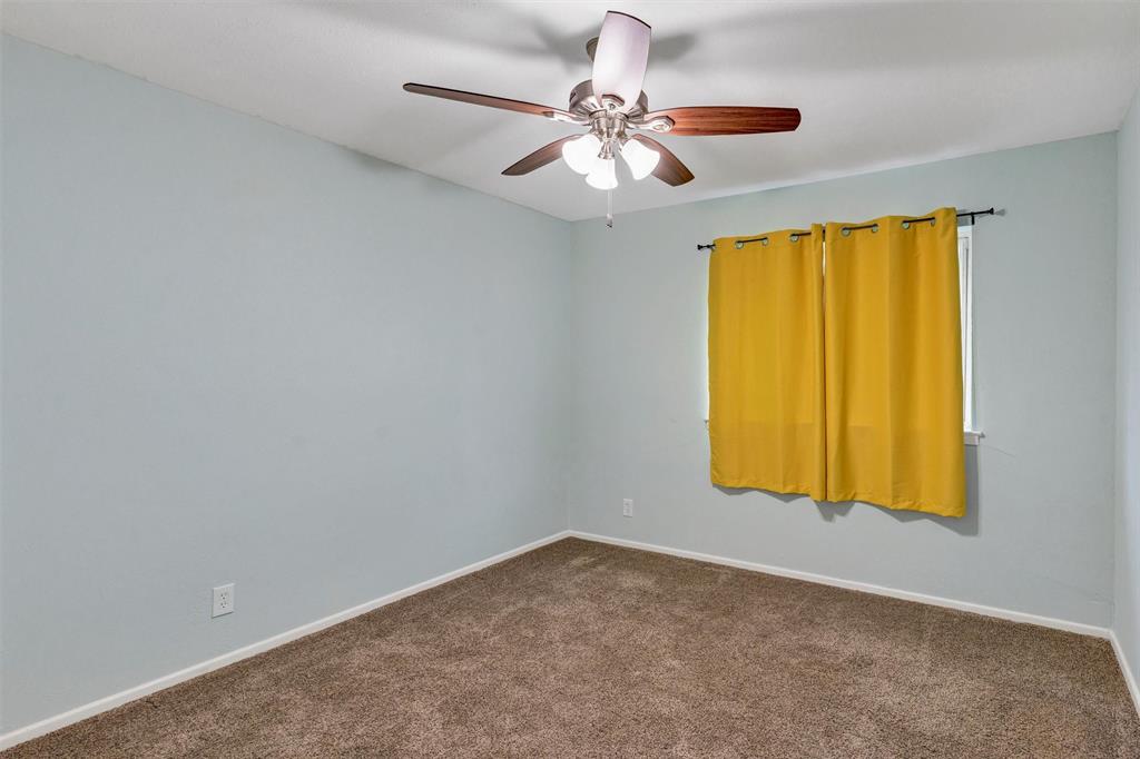 1009 Russell Road Everman, TX 76140 - Photo 17 of 20 an empty room with windows and fan