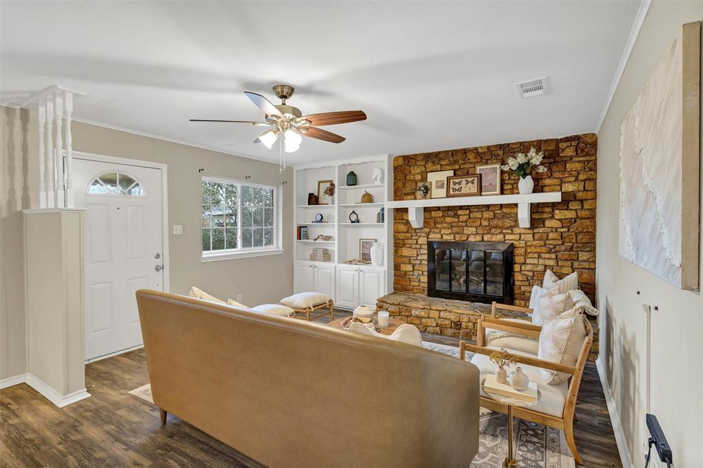1009 Russell Road Everman, TX 76140 - Photo 5 of 20 a living room with furniture window and a fireplace