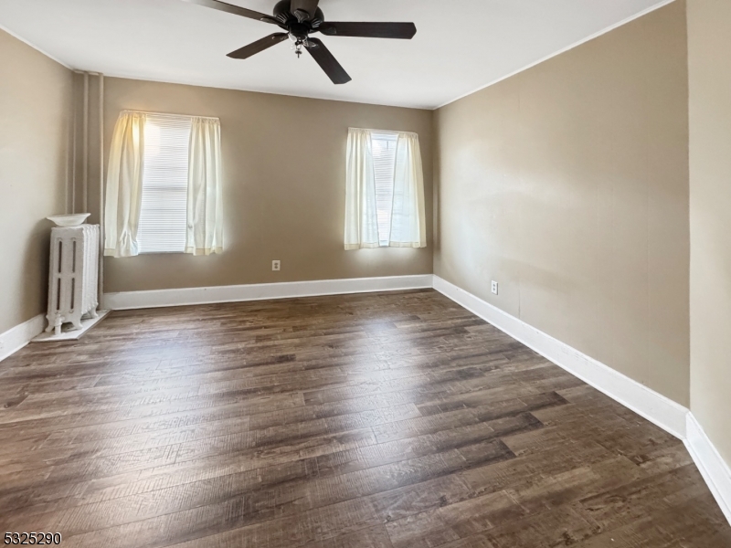 62 Summit Avenue, Unit B Phillipsburg, NJ 08865 - Photo 3 of 9 an empty room with wooden floor and windows